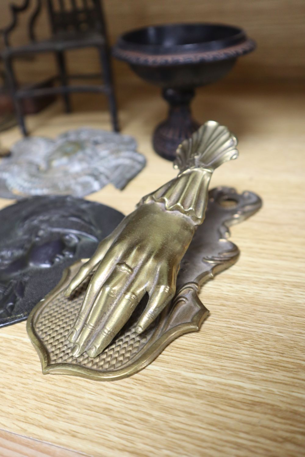 A group of 19th century iron and bronze ornaments, plaques, watch holder and urn